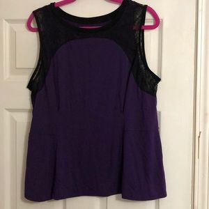Purple peplum top with black lace embellishments.